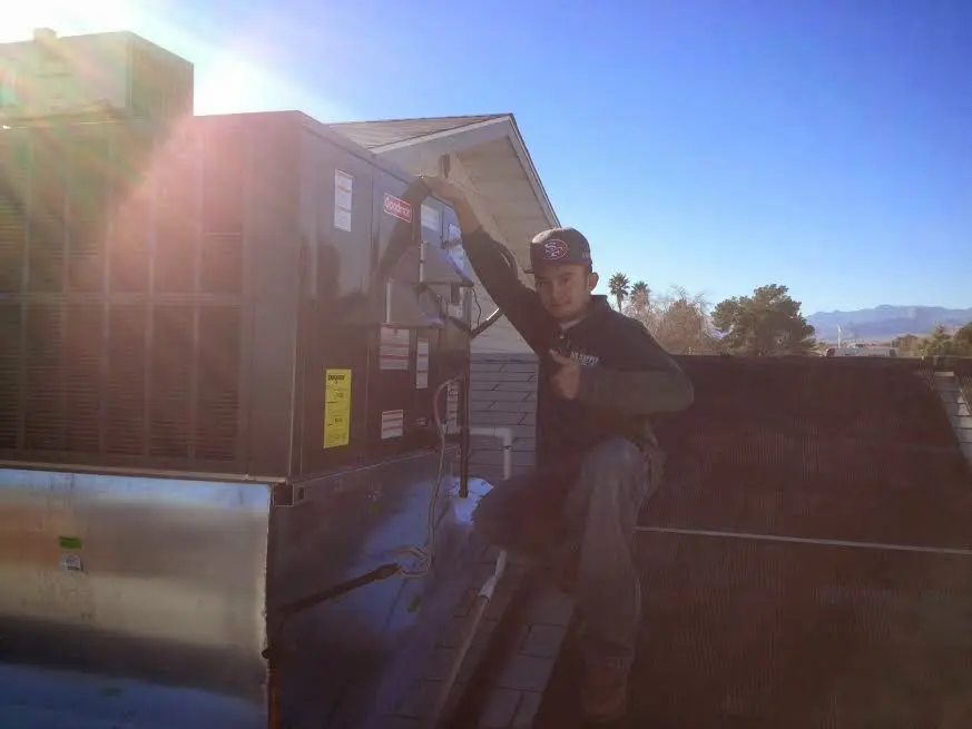HVAC technician performing AC Tune-Up on a rooftop unit in Catasauqua